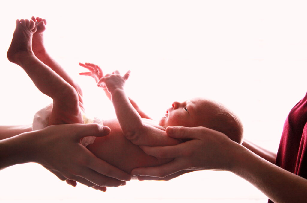 close up newborn against white background